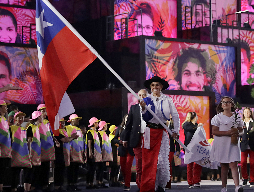 Erika Olivera carries the flag of Chile during the opening ceremony for the 2016 Summer Olympics in Rio de Janeiro, Brazil, Friday, Aug. 5, 2016. (AP Photo/Matt Dunham)